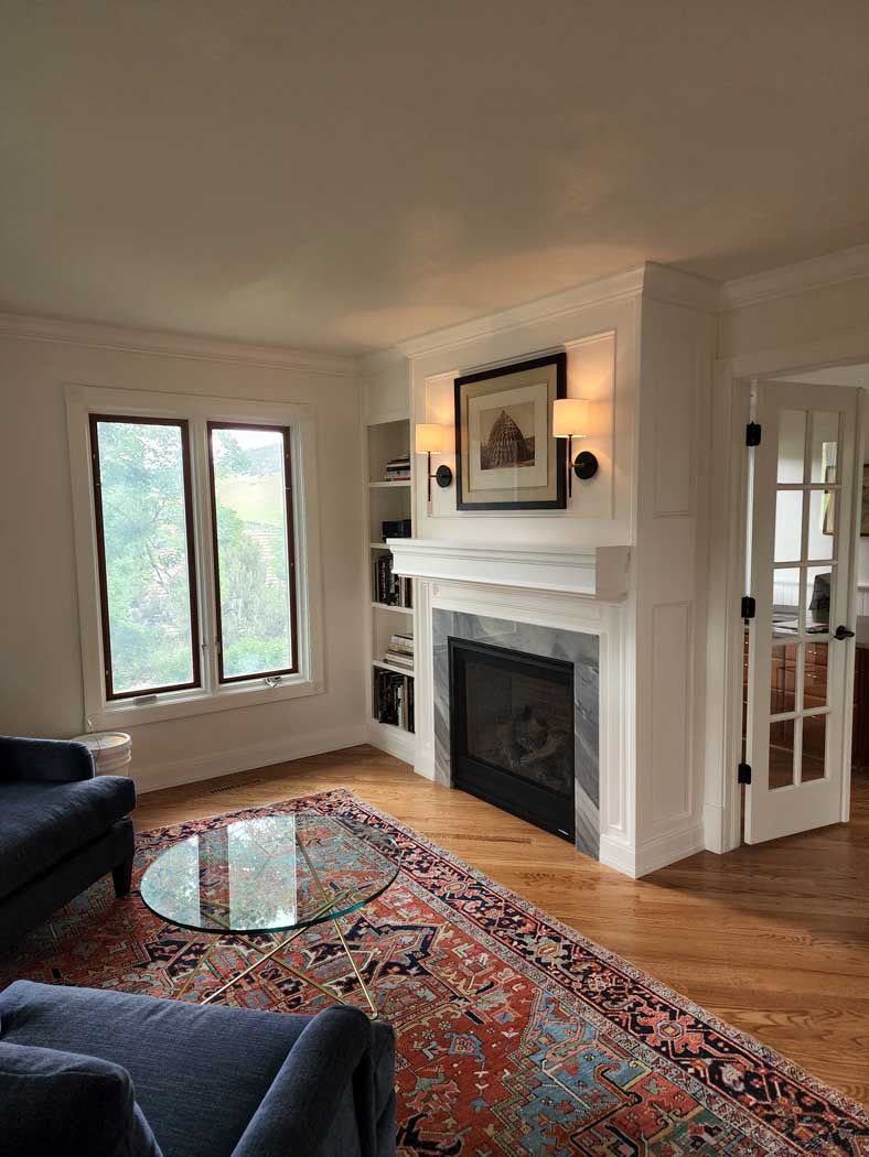 A living room with a fireplace and a flat screen tv