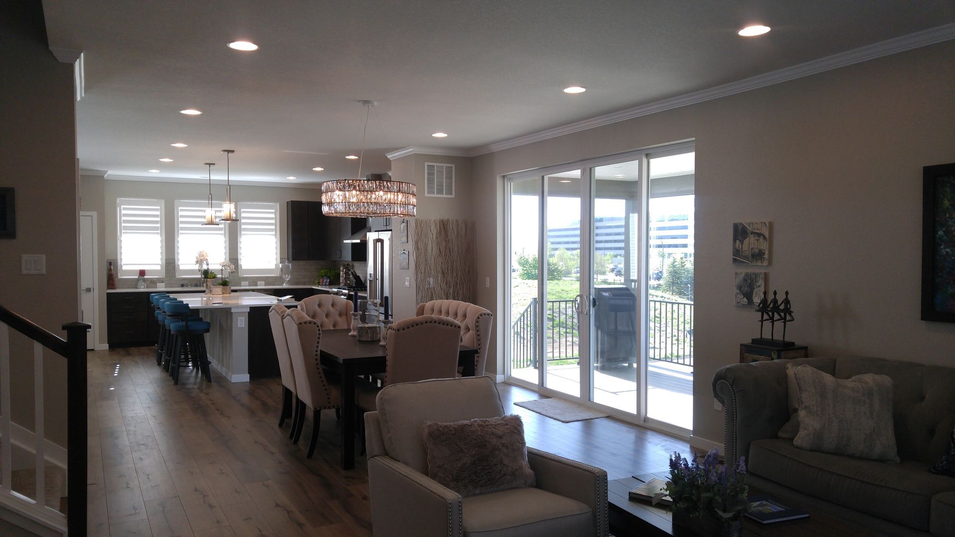 Open-plan living space with kitchen, dining area, and living room. Large sliding glass doors lead to a patio.