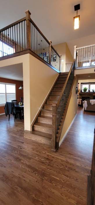 Indoor staircase with wooden steps and railing in a bright home interior