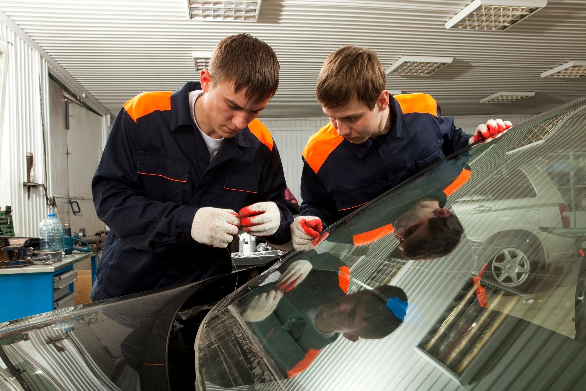 Men in uniform working on a car | Auto Glass Repair Fairfield OH | Glasspro Inc