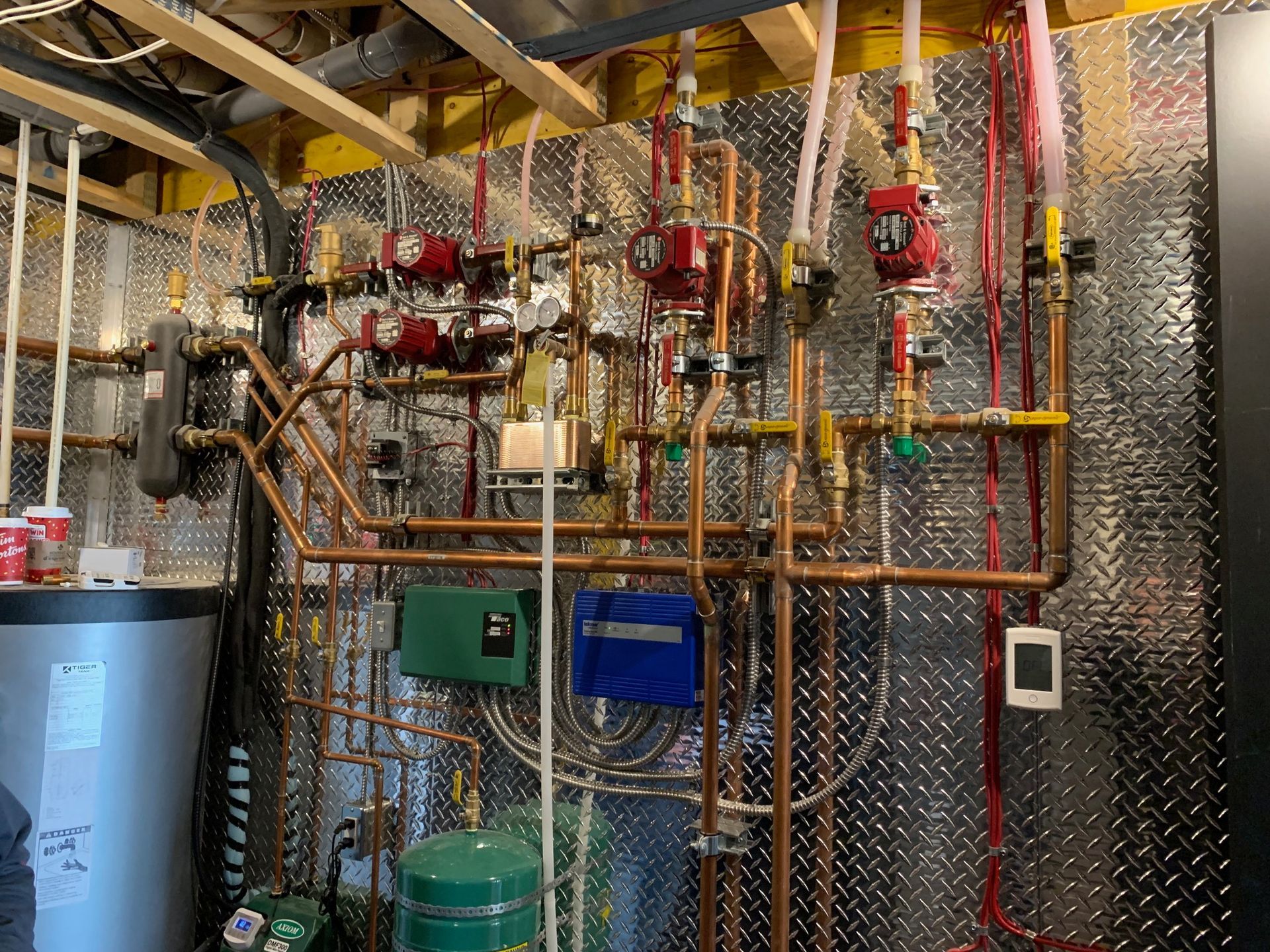 A room with a lot of pipes hanging from the ceiling.