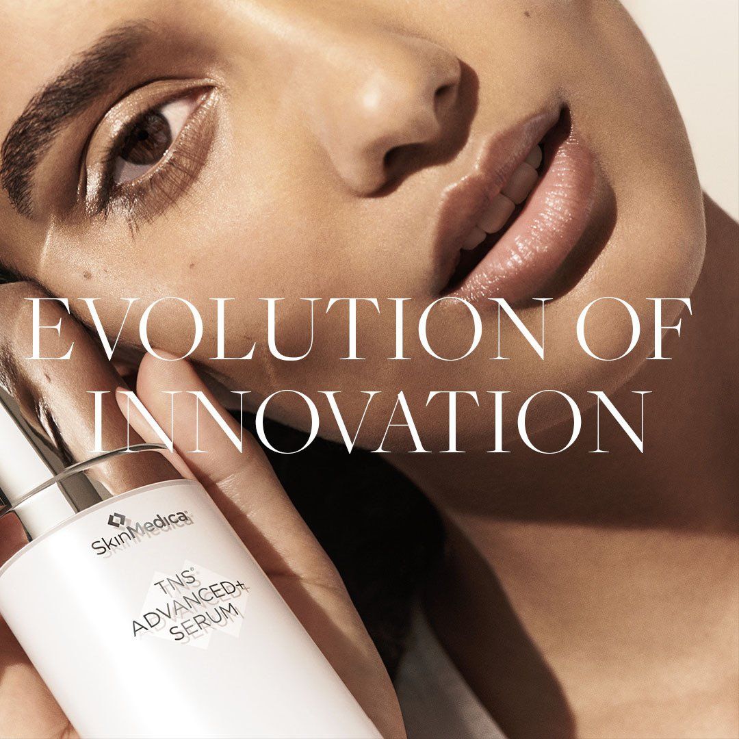 A woman is holding a bottle of advanced neck serum
