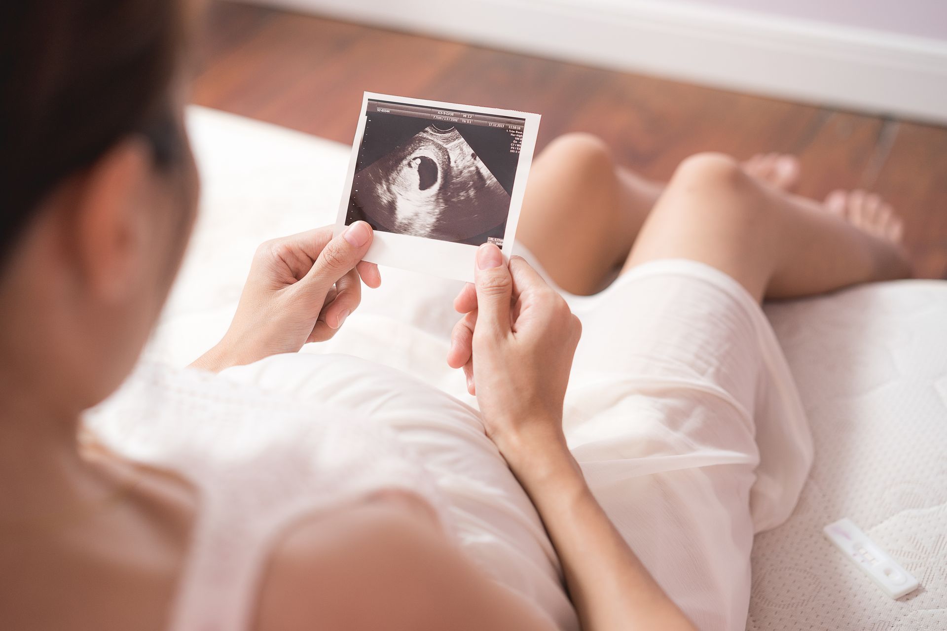 Woman viewing a photo of an ultrasound