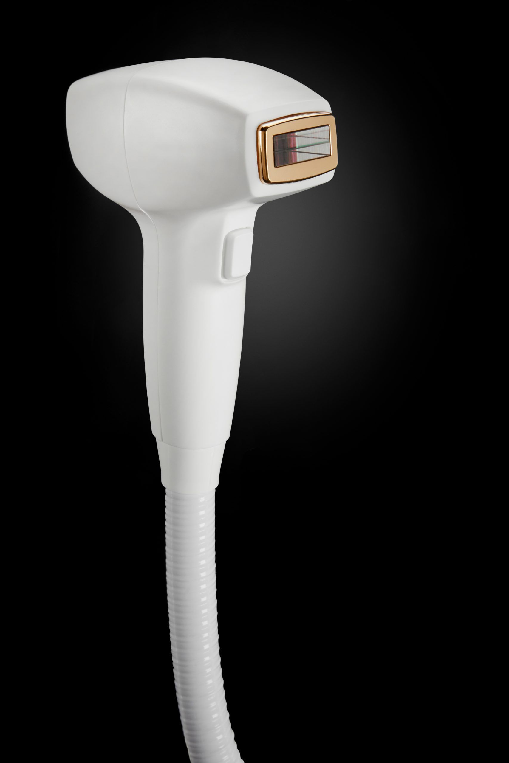 A close up of a hair removal device on a black background.