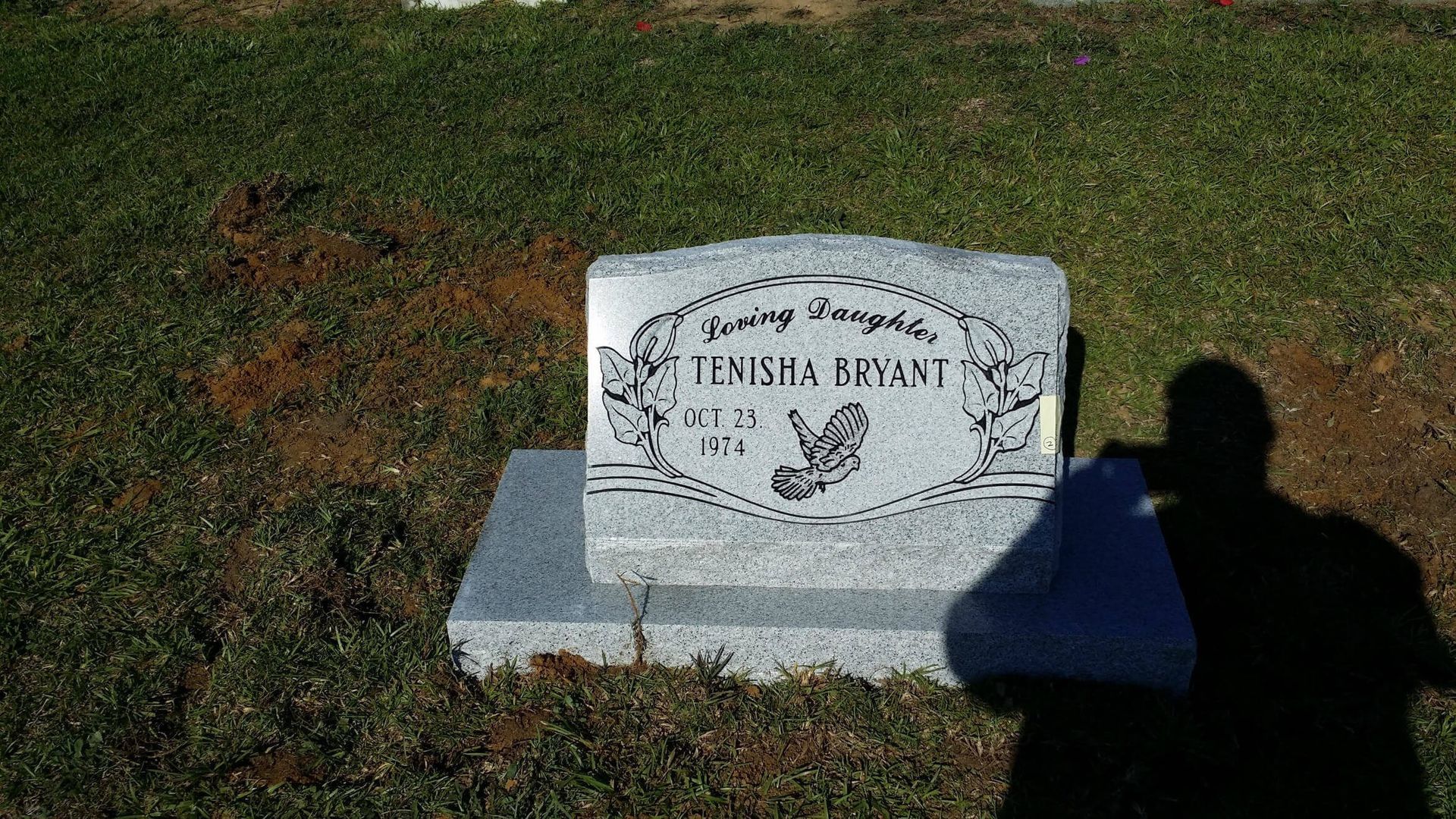 Headstone of Temisha Bryant in a grassy cemetery.
