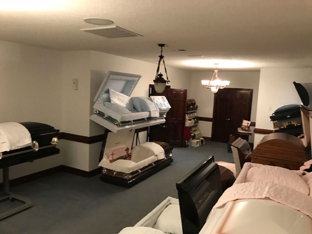 An interior of a room with several coffins on display.