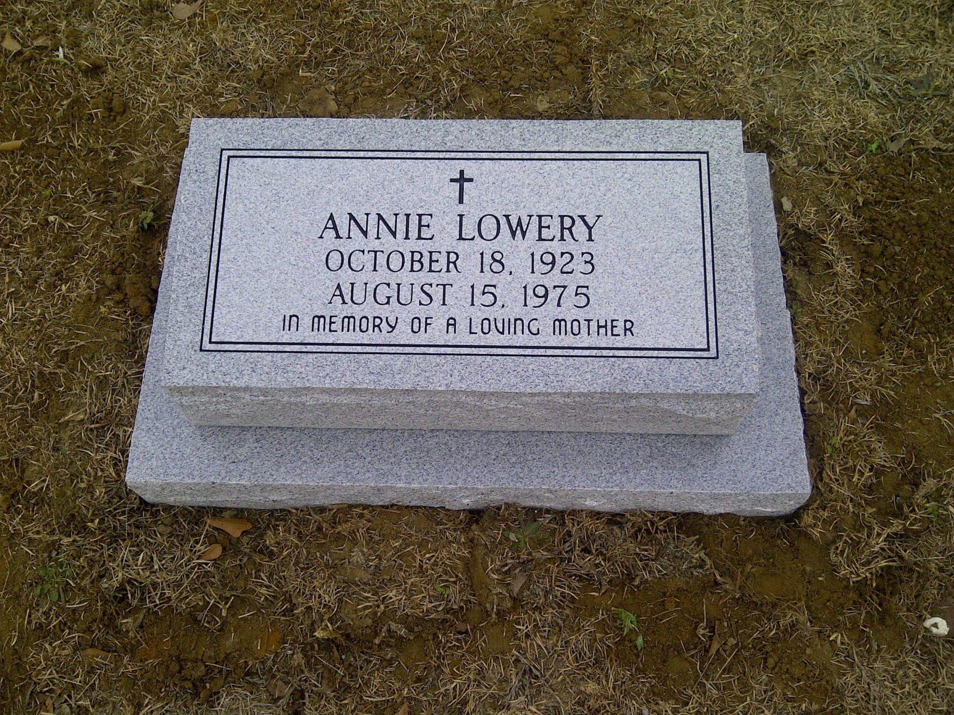 Gravestone of Annie Lowery, dates 1923-1975, with cross, 