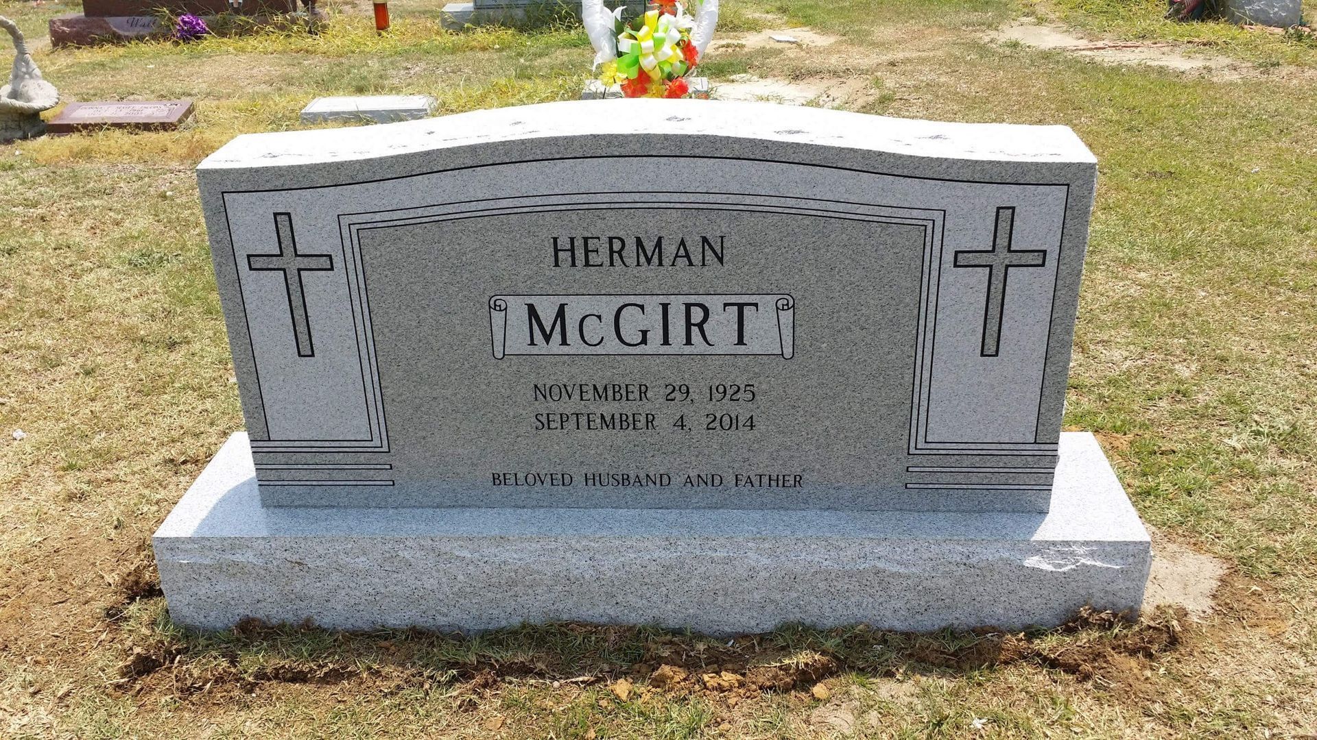 Gray headstone with cross, name 