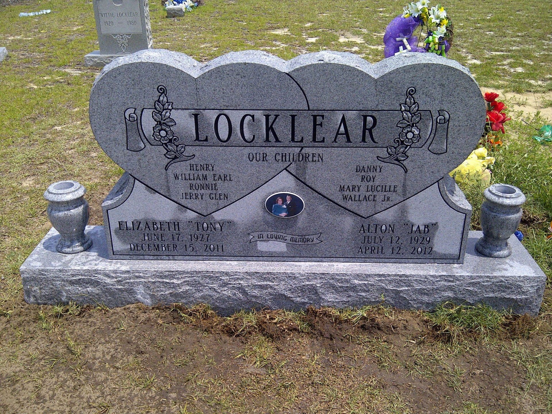 Gray granite headstone with two joined hearts, 