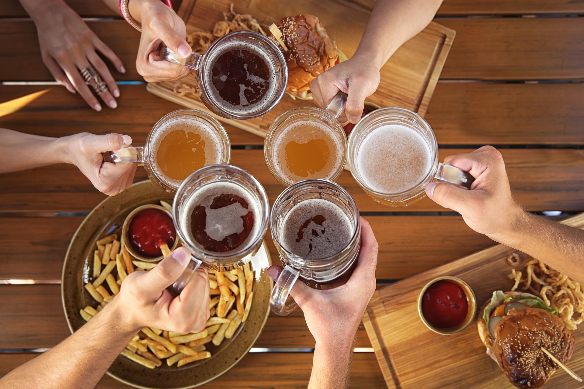 Friends cheering with beer at dinner