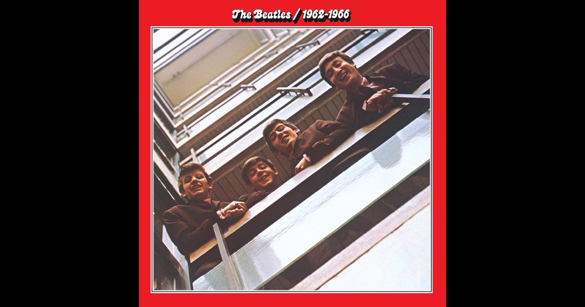 The Beatles looking down from a balcony. They are in brown suits and smiling. Red border with