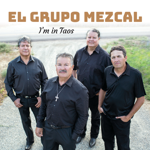 Four men in black shirts stand on a road, with