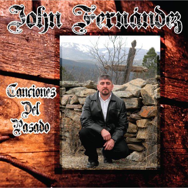 Album cover: John Fernandez, dark-haired man by stone wall.