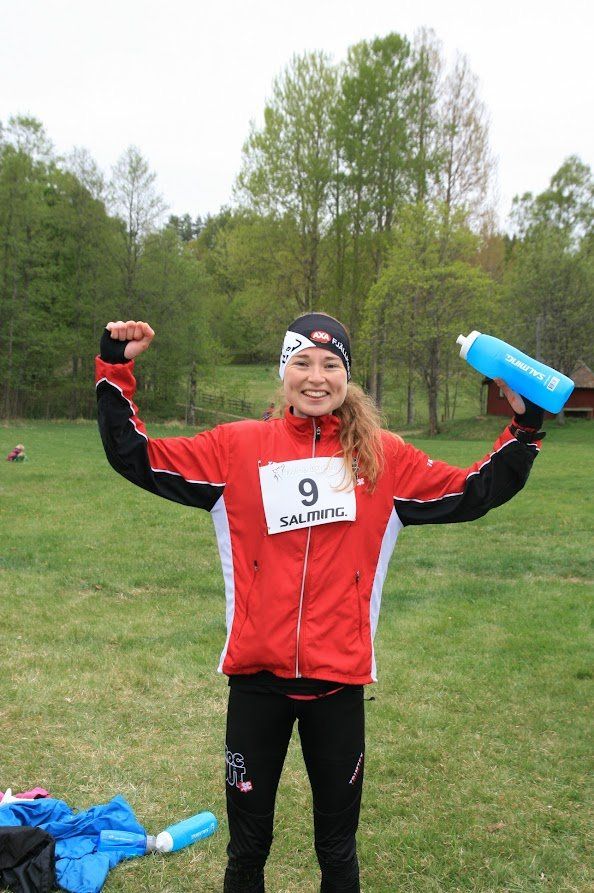 A woman wearing a red jacket with the number 9 on it