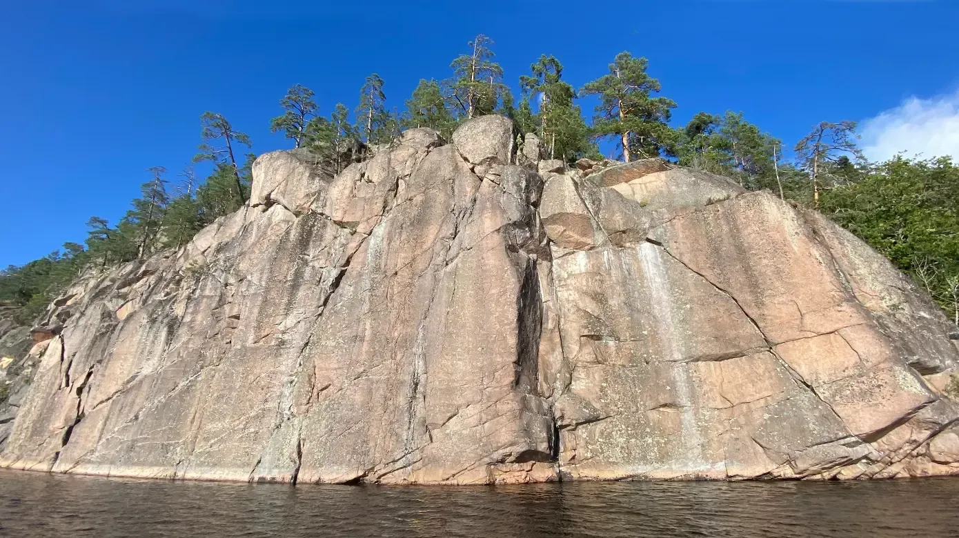 A large rocky cliff overlooking a body of water.