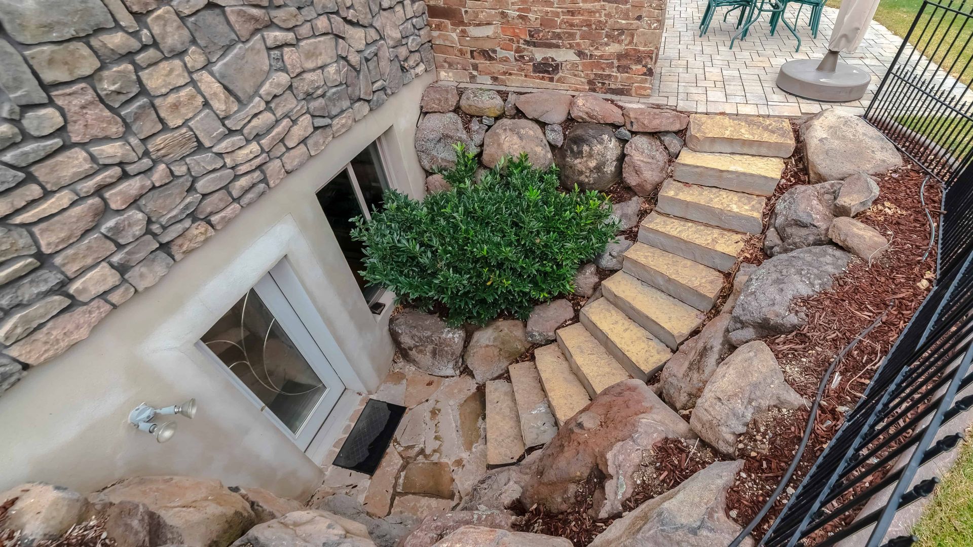 concrete stairs going to door downstairs