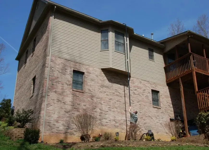 A large brick house with a balcony on the second floor