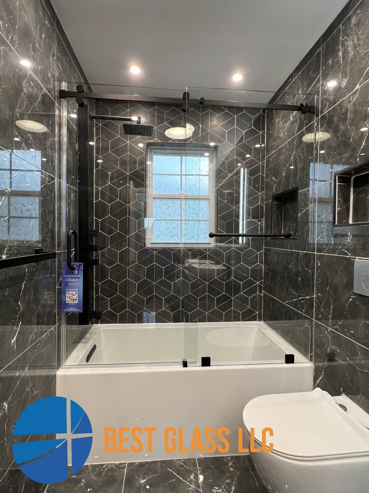 A bathroom with a bathtub , toilet and shower stall.