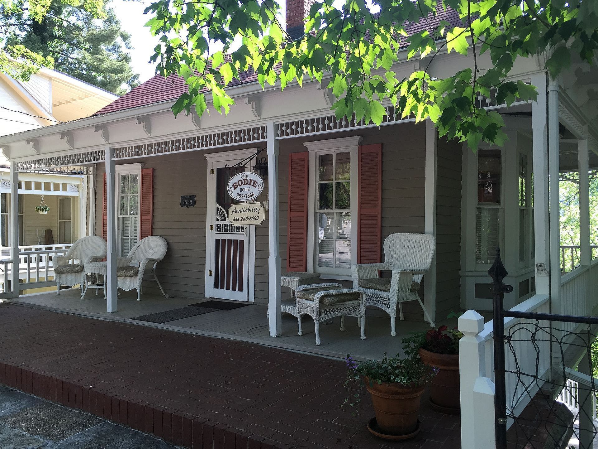 A house with a porch and a sign that says ' bakery ' on it