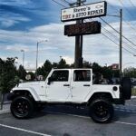 white jeep near mile stone | Steve's Tire & Auto Repair