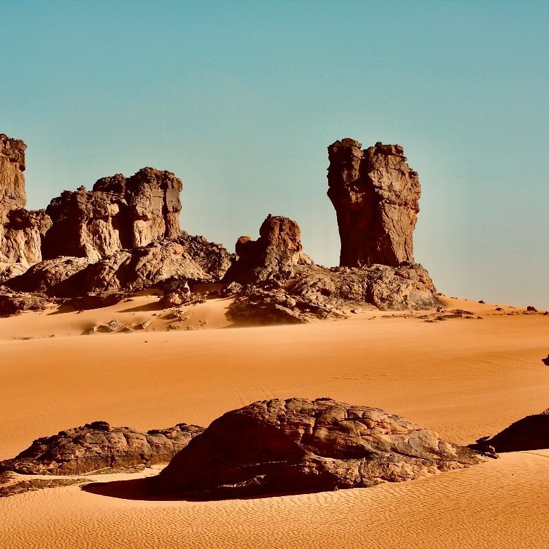 A rock formation in the middle of a desert