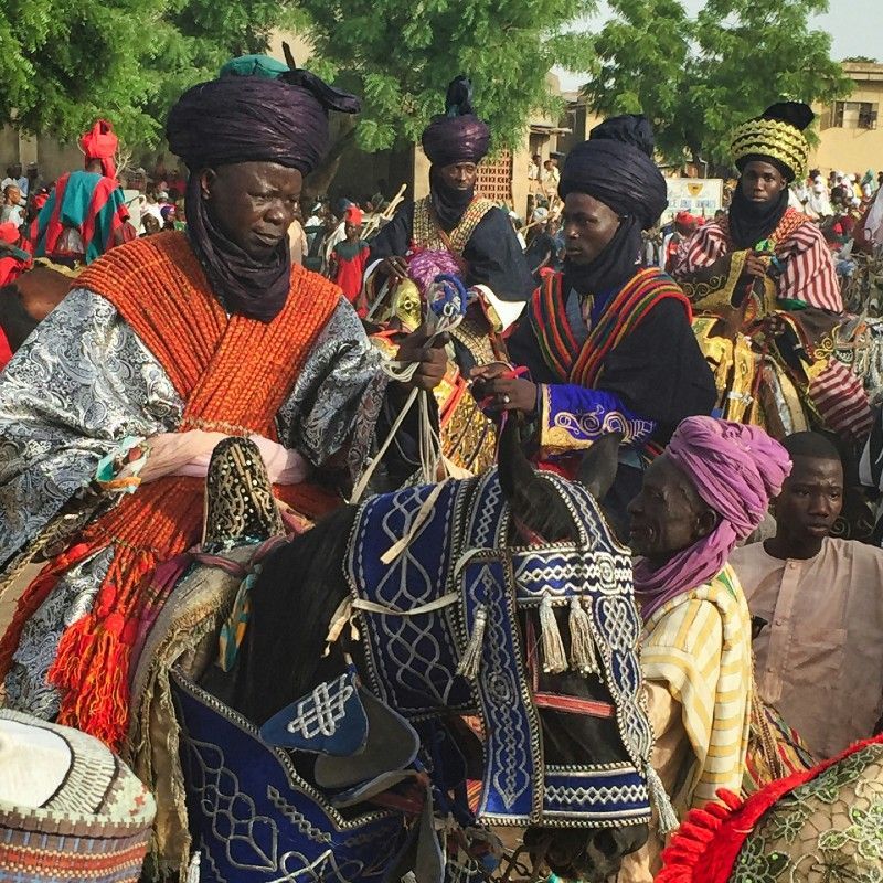 This vibrant image captures the splendor of the Hawan Daushe Durbar Festival in Nigeria, where men dressed in traditional attire ride elaborately adorned horses along the parade route. A celebration of heritage, royalty, and community, the Durbar is a dazzling display of color, music, and horsemanship held in northern cities like Kano and Katsina. It’s one of Nigeria’s most iconic cultural events. Discover the richness of Nigeria’s traditions with Connect DMC, your trusted expert in crafting authentic experiences. Africa DMC's, through its network of great locally based tour operators, organizes immersive journeys to Nigeria’s most captivating festivals and cultural sites.