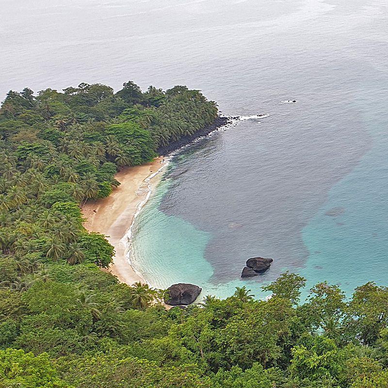 An aerial view of a small island in the middle of the ocean surrounded by trees. 
São Tomé & Príncipe enchants with emerald rainforests, volcanic peaks, secluded beaches, and warm island culture—all in one tranquil destination.
Discover São Tomé & Príncipe with Africa DMC’s trusted network for your local tour operator and travel agent.