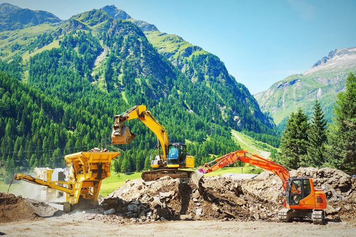 two excavators clearing gravel and site grading two excavators clearing gravel and site grading
