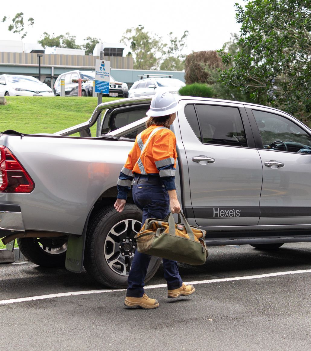 A male and a female Hexeis staff member conversing outdoors. 