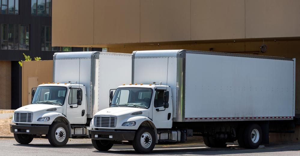 Tailwind box trucks loading at a warehouse