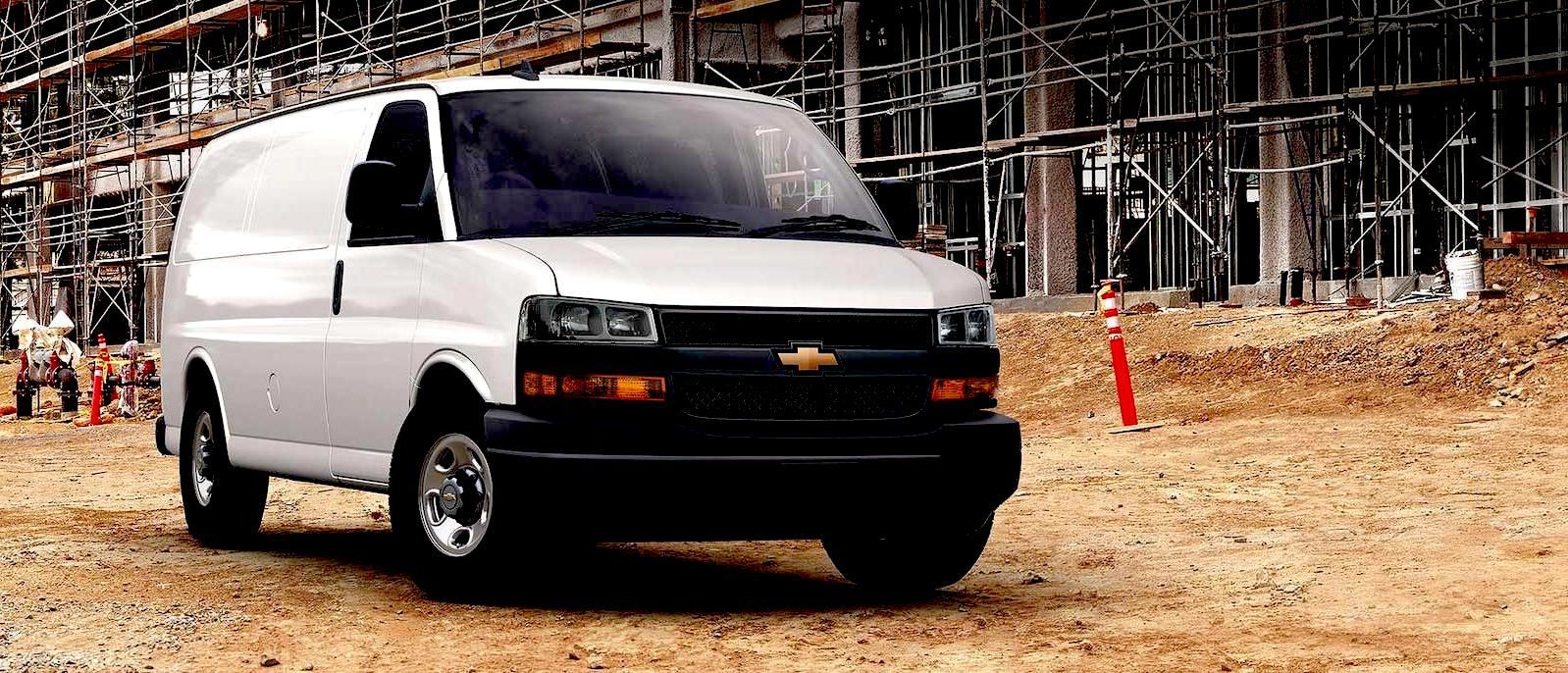 A white courier van is delivering to a construction site