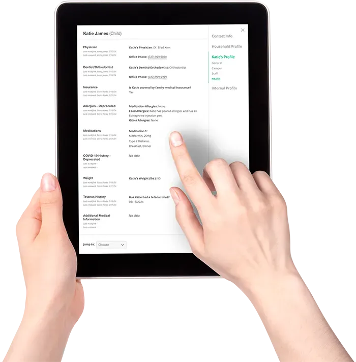A person is holding a tablet with their finger on the screen
