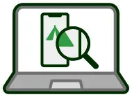 A laptop with a magnifying glass and a cell phone on the screen.