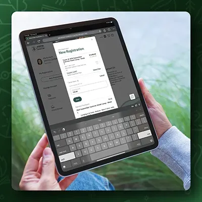 A person is holding a tablet with a keyboard on it.