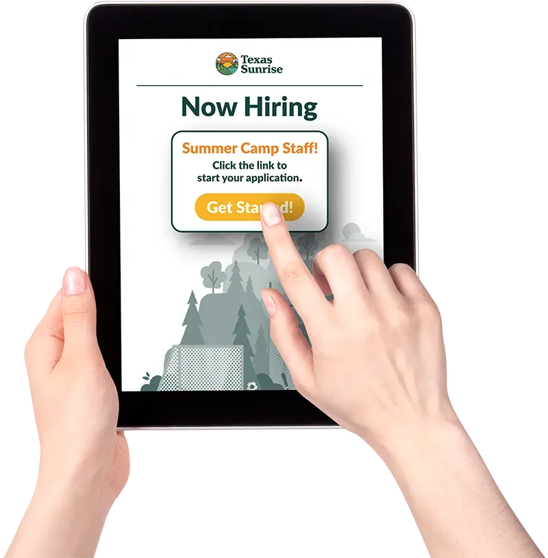 A person is holding a tablet that says now hiring