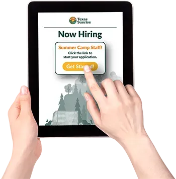 A person is holding a tablet that says now hiring