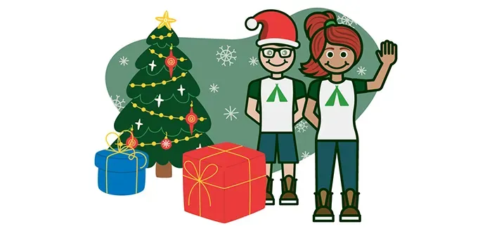 A boy and a girl standing next to a Christmas tree with presents.