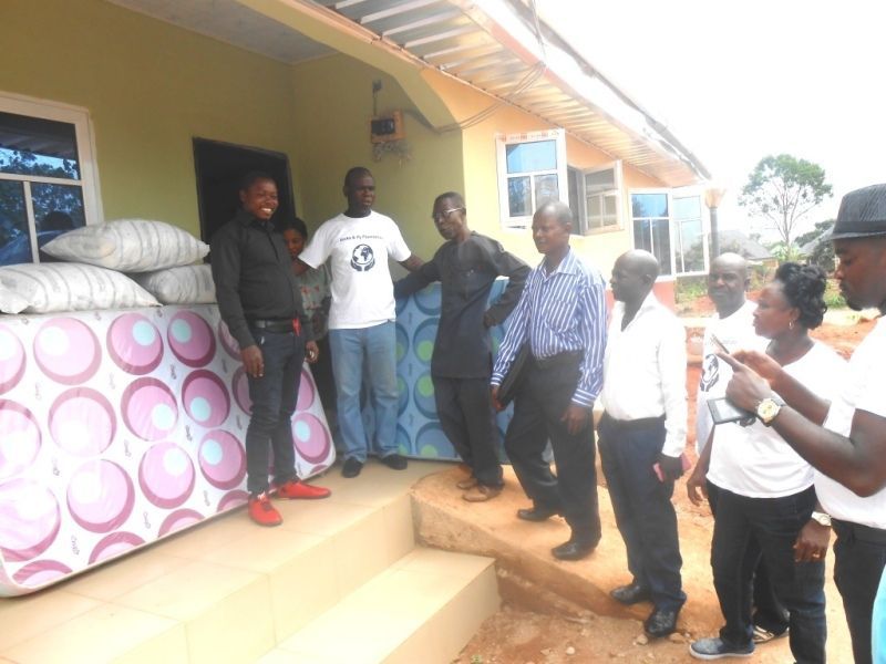 A group of people standing in front of a house
