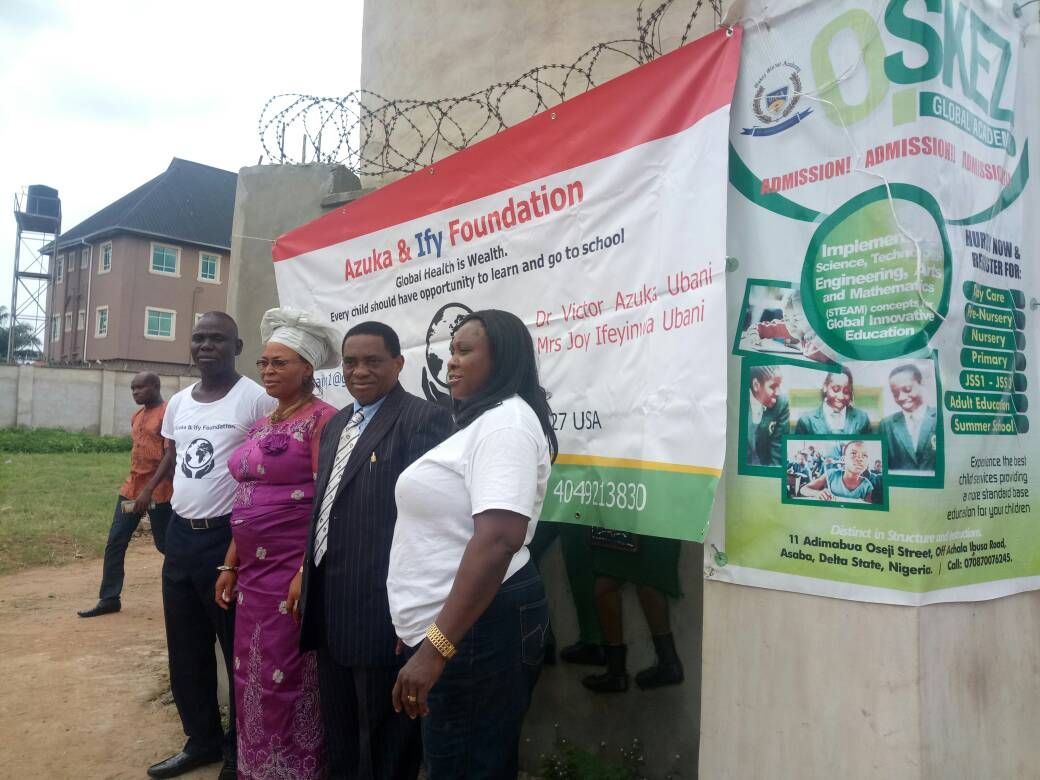 A group of people standing in front of a sign that says foundation