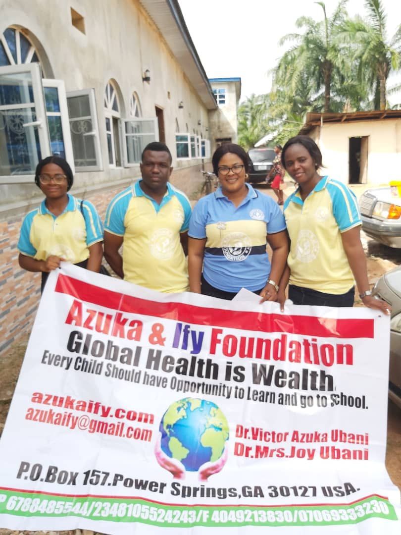 A group of people holding a sign that says global health is wealth