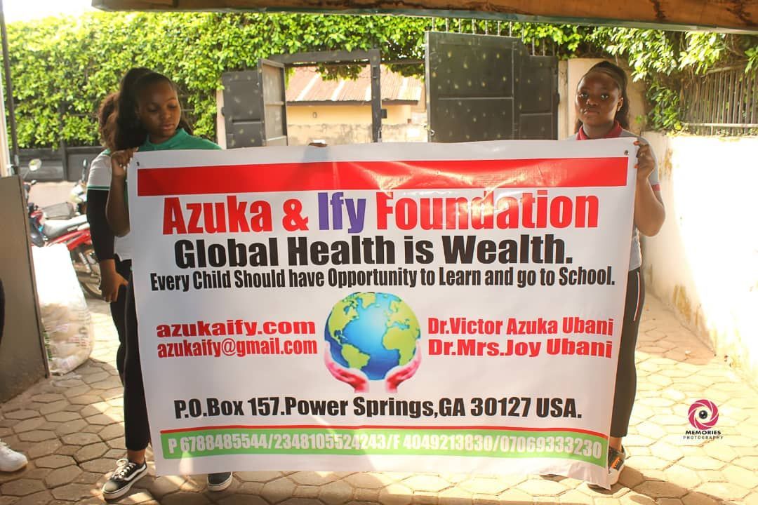A group of people holding a sign that says global health is wealth
