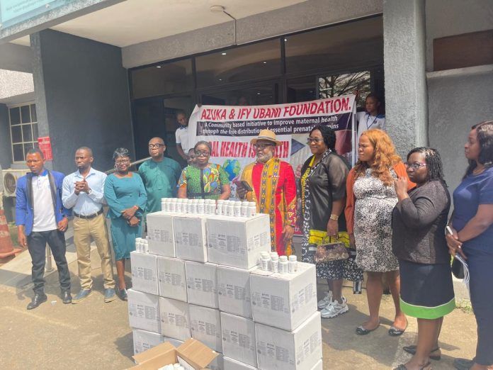 A group of people are standing around a pile of boxes.