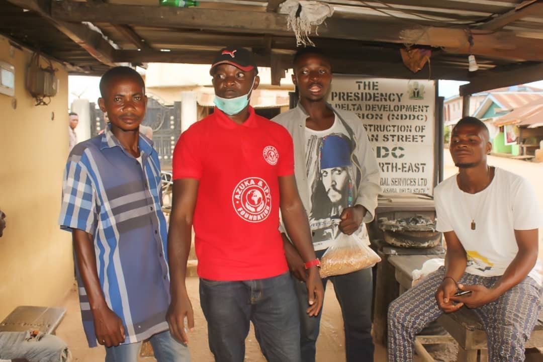 A group of men are posing for a picture in front of a sign that says pregnancy