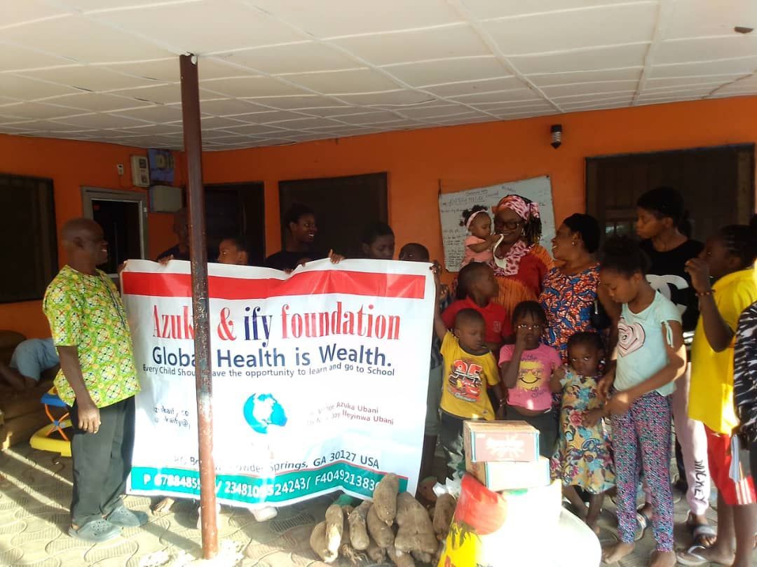A group of people standing around a sign that says global health is wealth.
