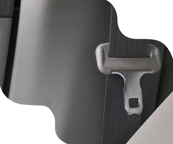 Gray seat belt buckle inserted into receiver on a gray car seat.