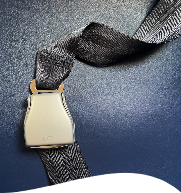 Airplane seatbelt fastened against a blue seat.