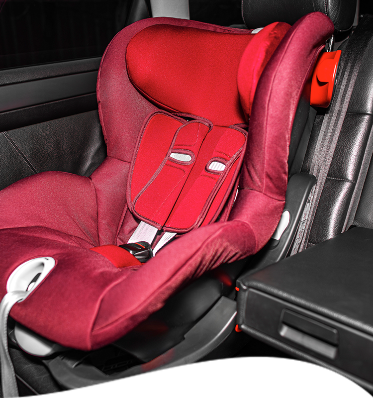 Red car seat in a black car.