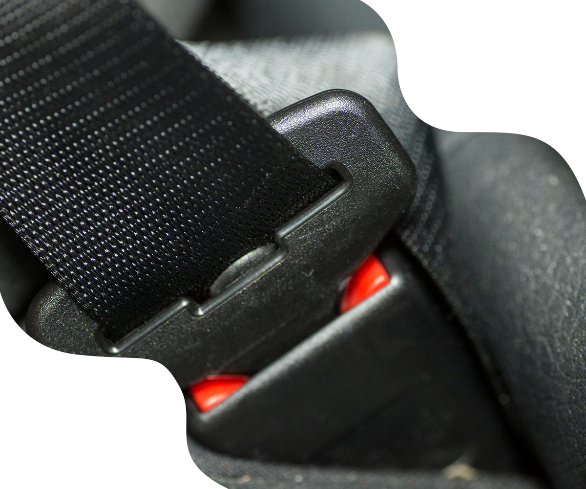 Black seatbelt buckle latched, with a red release button.