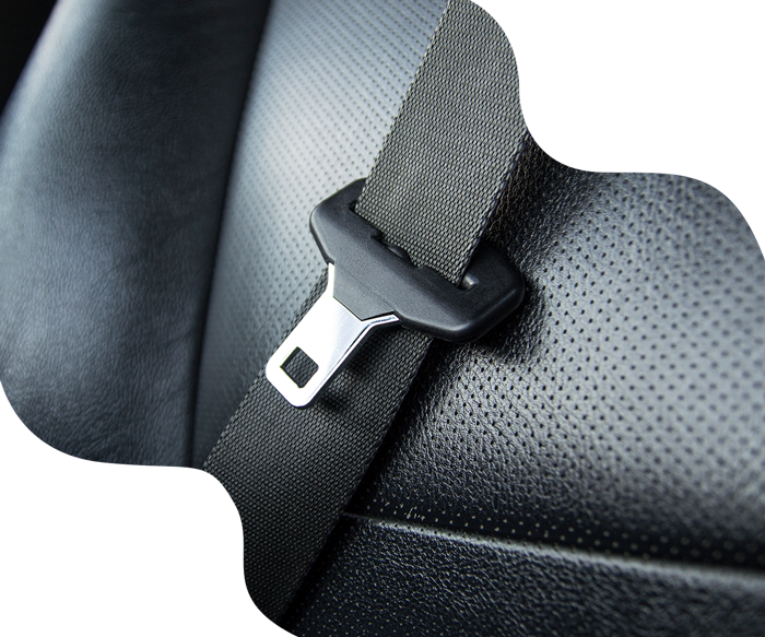 Black seat belt buckled in a black car seat.