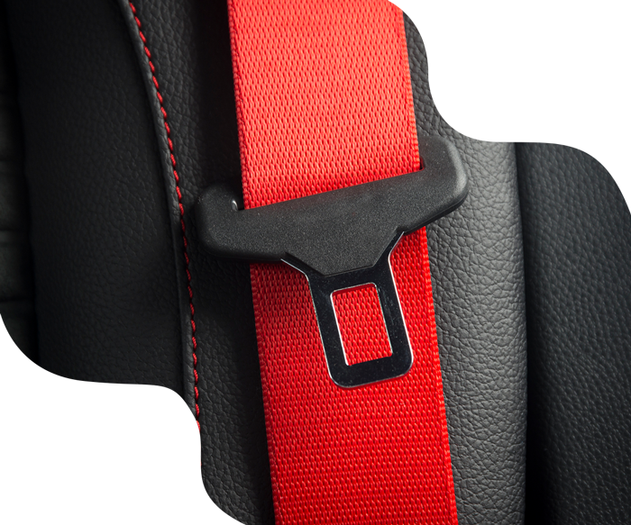Red seatbelt buckled across black leather car seat.